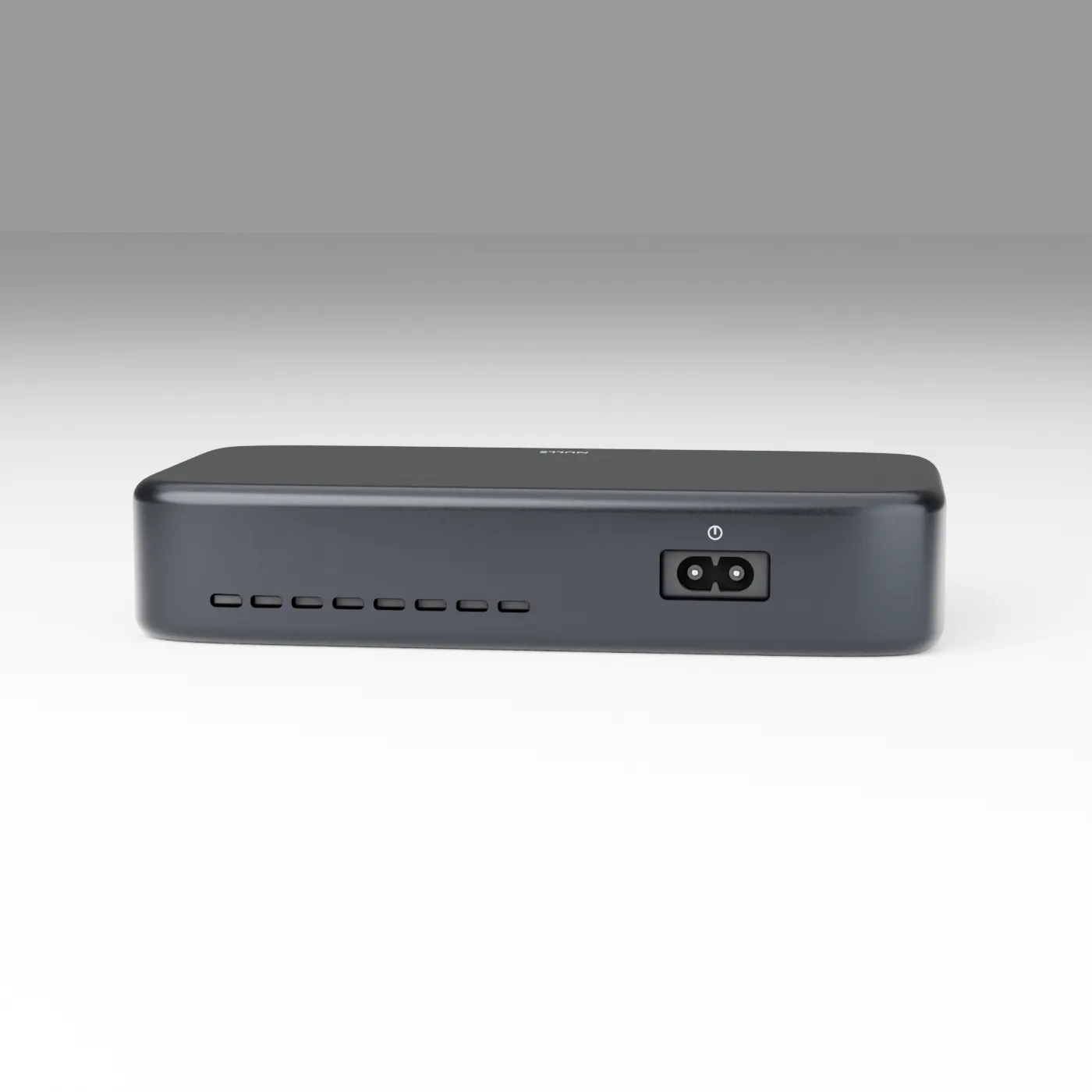 Rear view of the NULLE USB-C hub showing ventilation slots and its recessed AC power inlet.